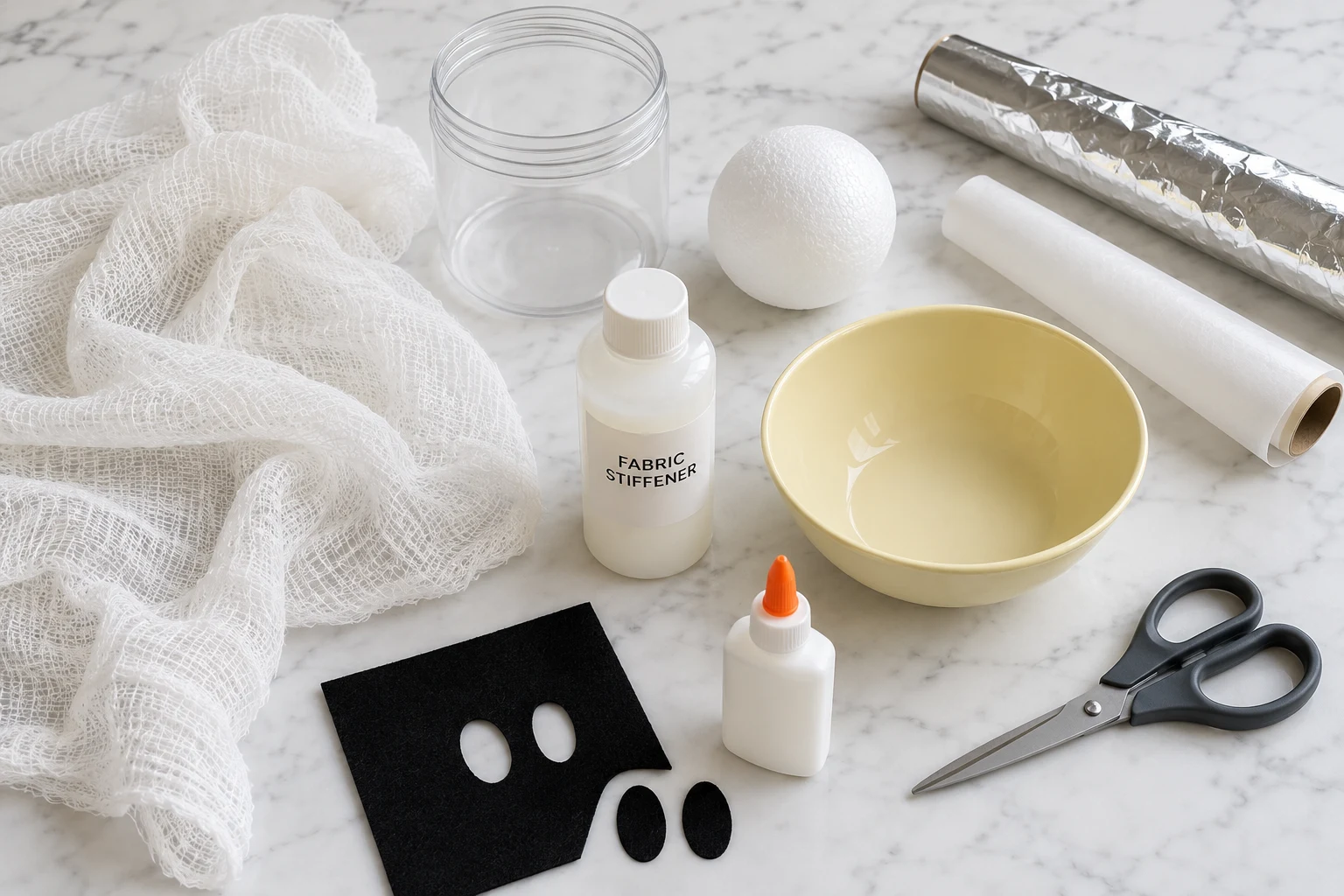 Cheesecloth, fabric stiffener, a container, foam ball, foil, wax paper, scissors, bowl and black felt.